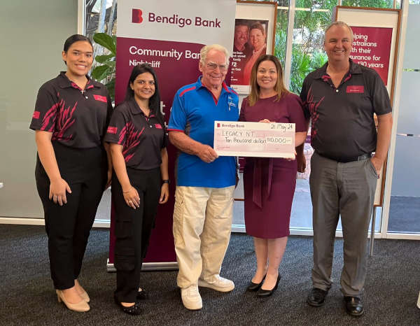Nightcliff Community Bank staff present a cheque for $10,000 to NT Legacy